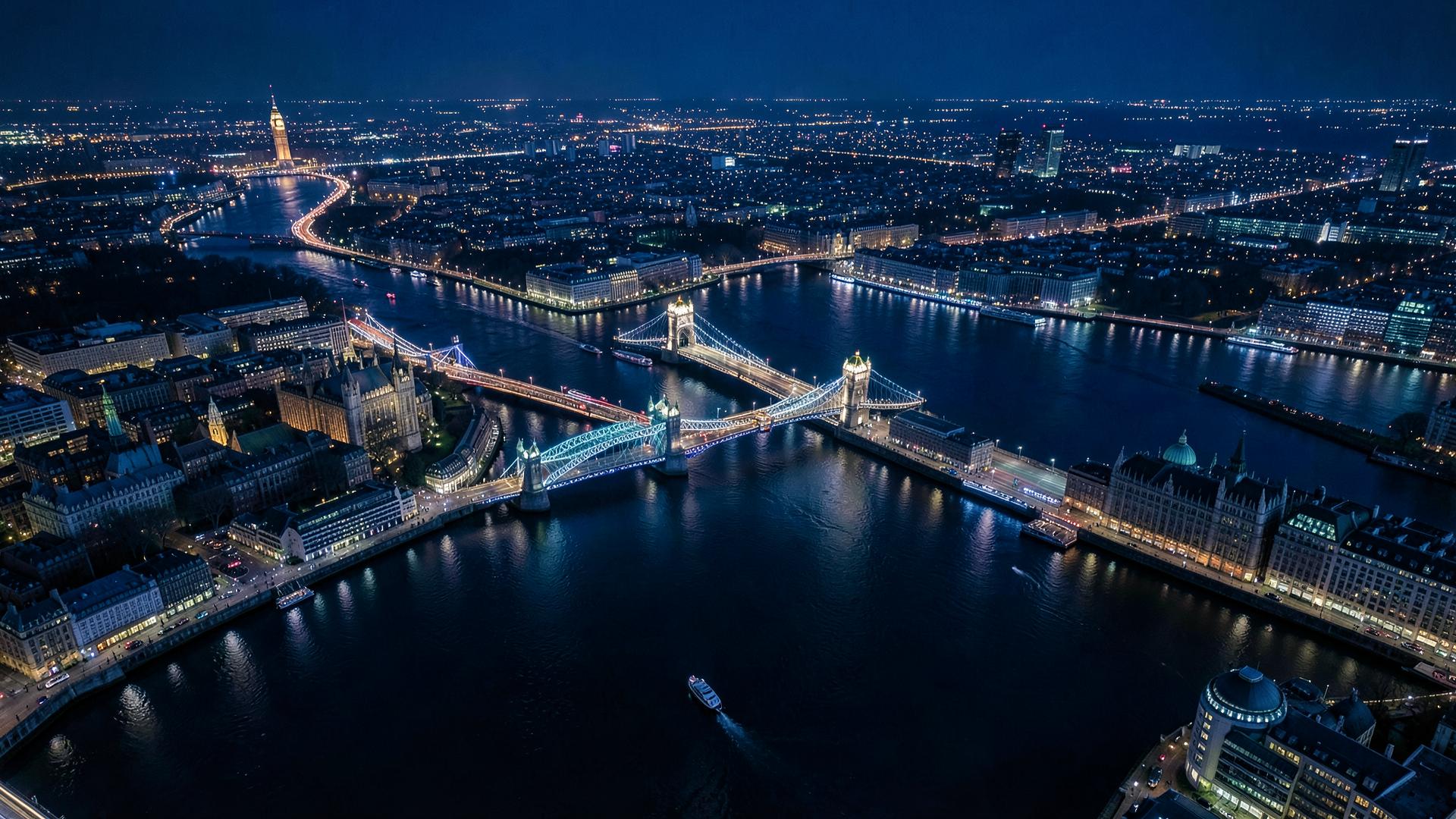 Vista aérea noturna de Londres com o Tâmisa e pontes iluminadas